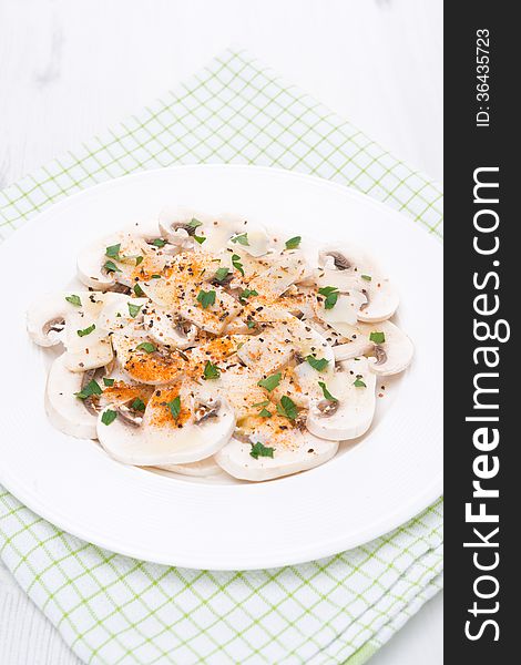 Salad of fresh mushrooms with spices and herbs, vertical
