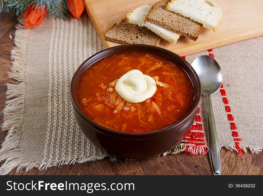 Russian and ukrainian red soup borsch with creme fraiche and bread