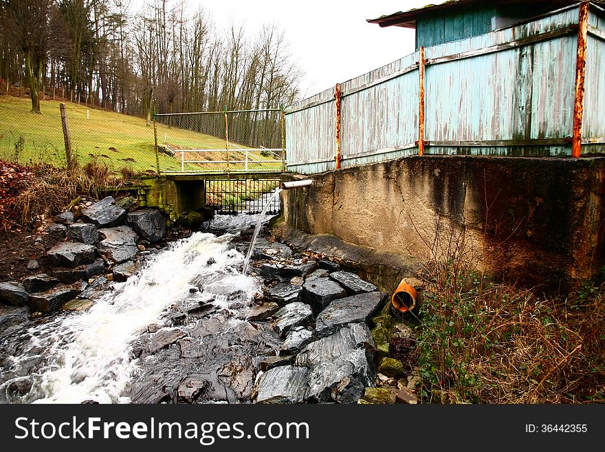 Stream flows in the river bed of stones