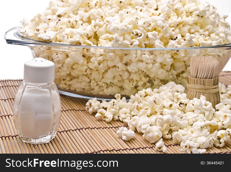 Wooden toothpicks, salt and popcorn on white background