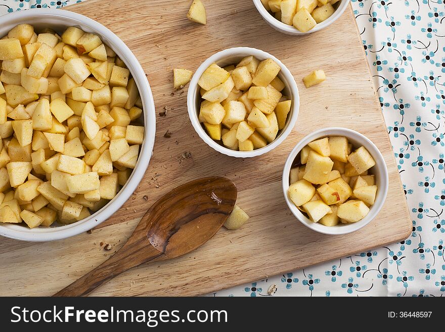 Chopped apples with sugar and spices in baking dishes. Chopped apples with sugar and spices in baking dishes.