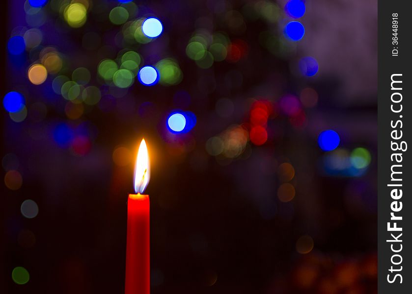 Lit candle with a blurred background