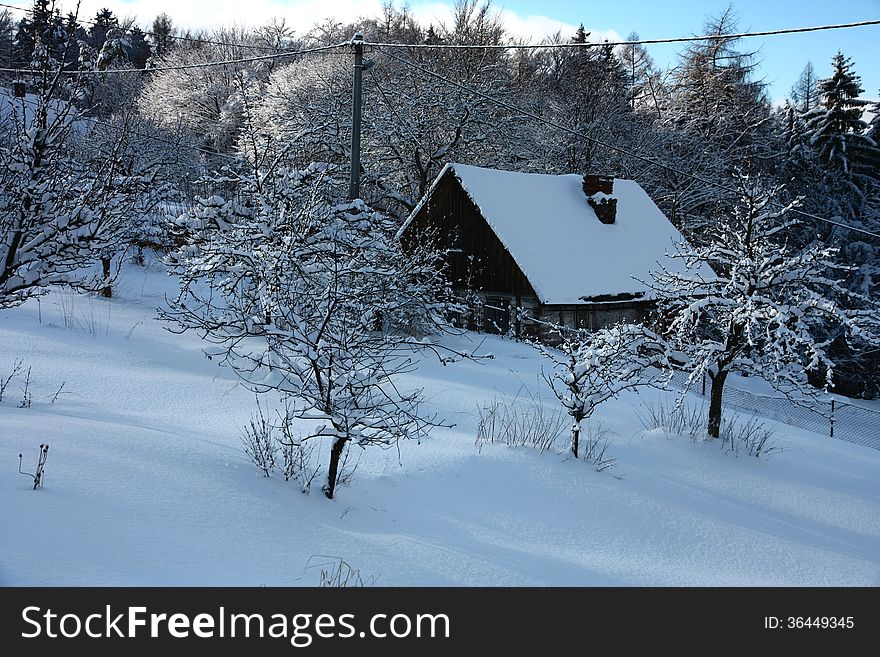 Cottage in snowy field, czech countryside cottage