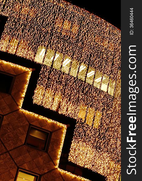 The front of an elegant store in vienna, austria covered with a curtain consisting of many small lights, thus generating a glitterig christmas illumination. The front of an elegant store in vienna, austria covered with a curtain consisting of many small lights, thus generating a glitterig christmas illumination