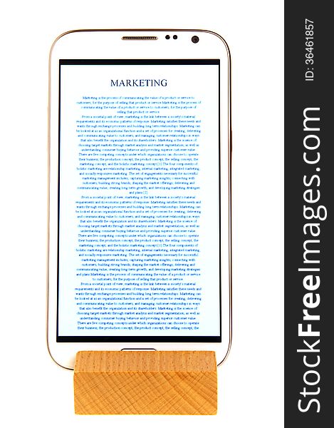 Mobile on wooden holder with reading app interface.