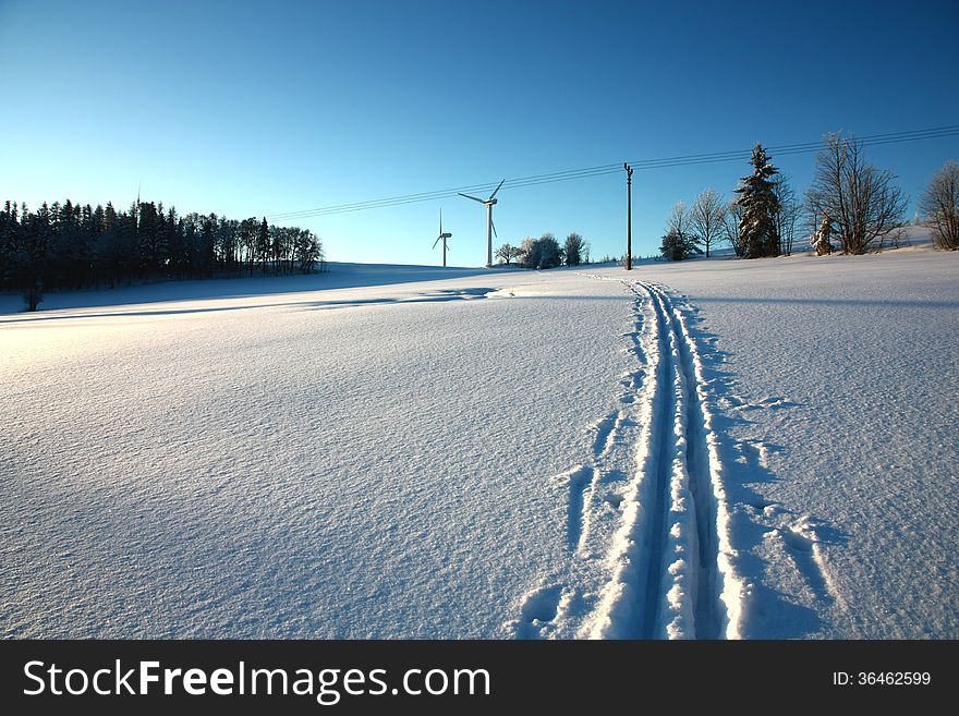 Electrical energy is in a winter landscape, track from skis in the snow