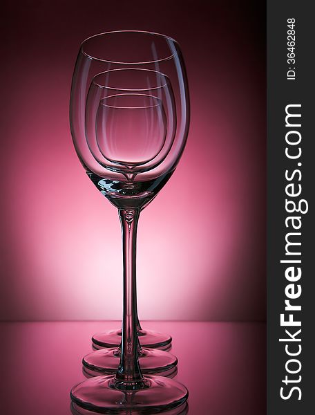 Three Wine Glass On A Burgundy Background