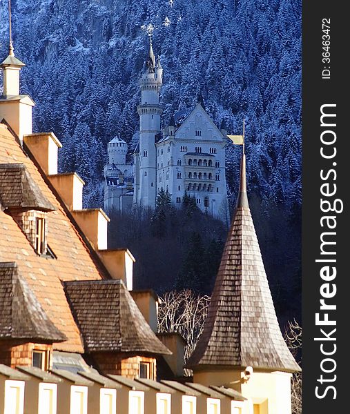 Neuschwanstein Castle, built by King Ludwig of Bavaria in the 1880s, as seen from Hohenschwangau Palace (Schloss Hohenschwangau).Hohenschwangau is the childhood residence of King Ludwig II of Bavaria and was built by his father, King Maximilian II of Bavaria. It is located in the German village of Hohenschwangau near the town of Fuessen in southwestern Bavaria, Germany, close to the border with Austria. Built on the ruins of an old castle the palace was constructed between 1833 and 1855.