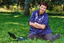 Woman With Laptop On Green Lawn. Stock Photo Woman With Laptop On Green Lawn. Stock Photo