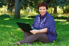 Woman With Laptop On Green Lawn. Stock Photography Woman With Laptop On Green Lawn. Stock Photography