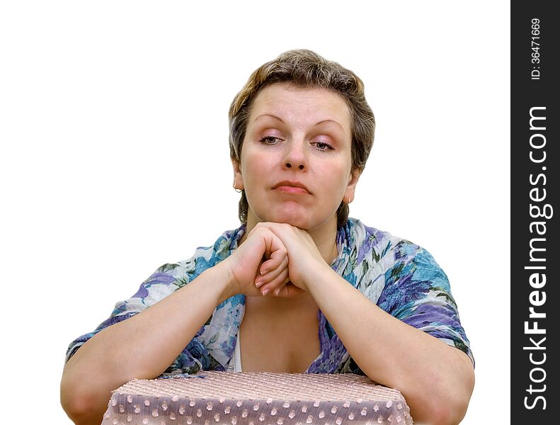 Isolated Portrait of a woman. Elbows are put on a chair. Hands support the head.