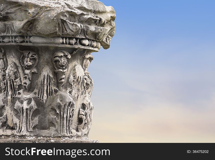 Fragments of ancient columns on sky background