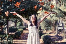 Beautiful Brunette Girl With Falling Leaves In The Autumn Stock Photos