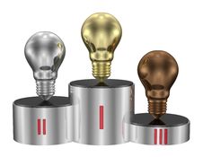 Golden, Silver And Bronze Light Bulbs On Cylindrical Pedestal. Front View Stock Photos Golden, Silver And Bronze Light Bulbs On Cylindrical Pedestal. Front View Stock Photos