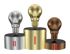 Golden, Silver And Bronze Light Bulbs On Cylindrical Pedestal Of Same Metals. Front View Royalty Free Stock Image Golden, Silver And Bronze Light Bulbs On Cylindrical Pedestal Of Same Metals. Front View Royalty Free Stock Image