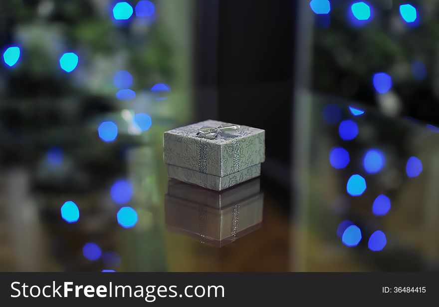 Silver gift box on the background of blue lights. Silver gift box on the background of blue lights