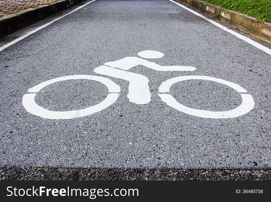 Asphalt road with cycle track and bike sign. Asphalt road with cycle track and bike sign.