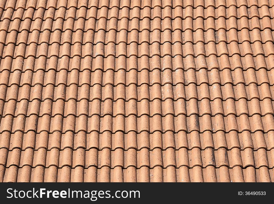 Red tile roof by bright sunny day