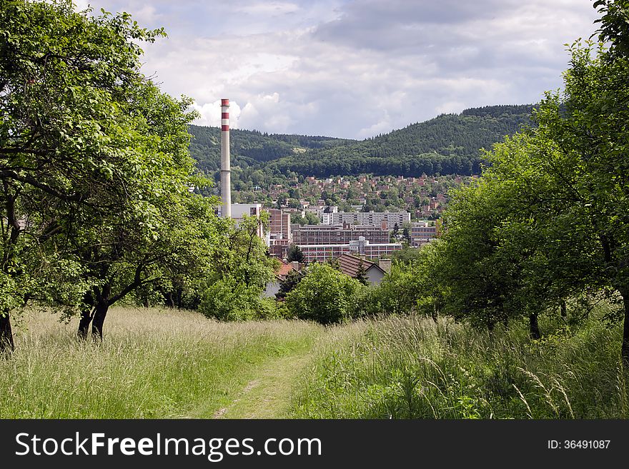 View of industrial city in a valley surrounded by green hills with forest, Zlin, Czech Republic. View of industrial city in a valley surrounded by green hills with forest, Zlin, Czech Republic.