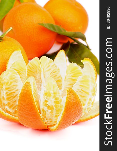 Fresh Ripe Tangerine with Segments and Citrus Peel and Some Full Body with Leafs closeup on white background