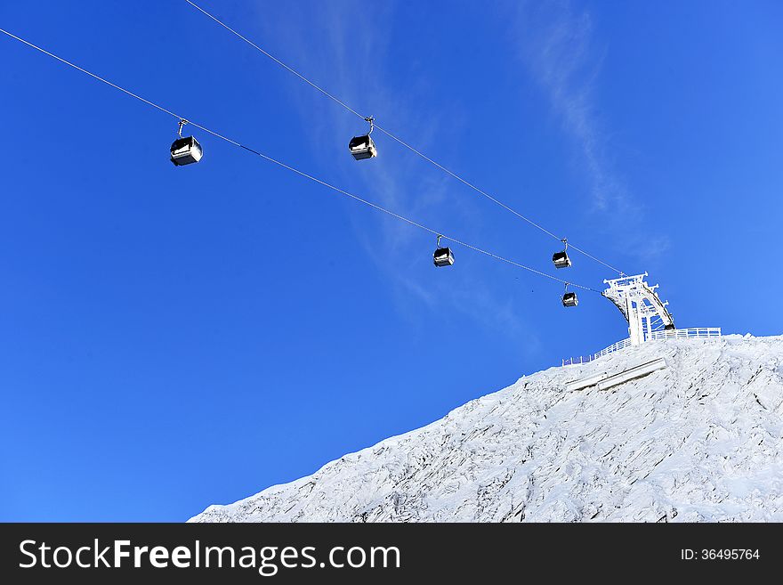 Ski lift chairs on bright winter day