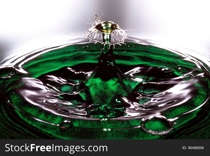 Collision of two drops of water in a green recipient. Collision of two drops of water in a green recipient