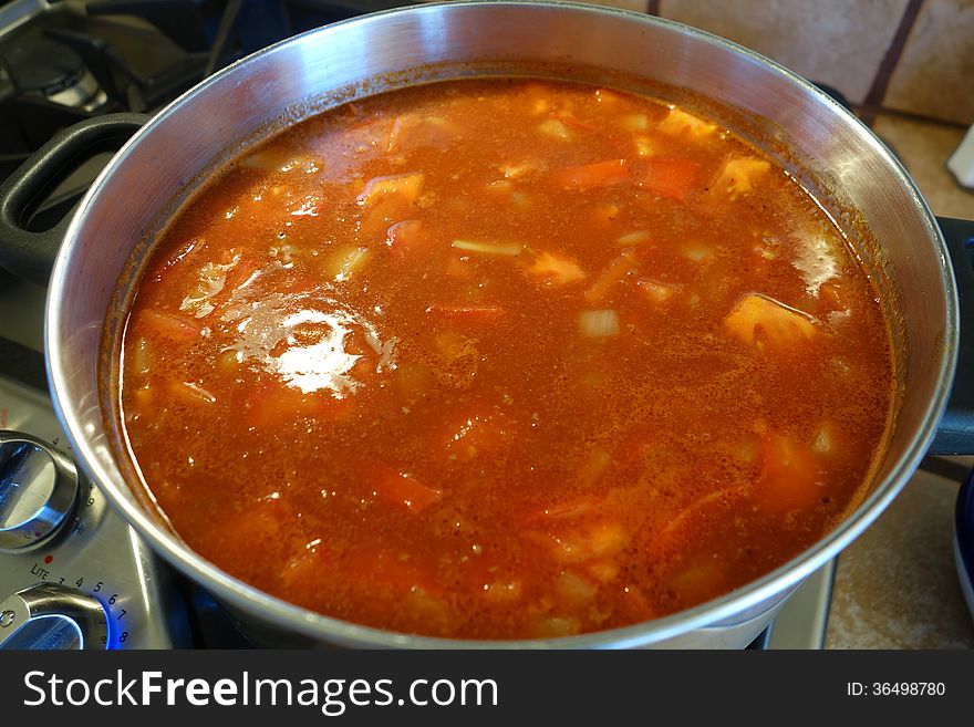 A picture of homemade soup cooking on the stove.