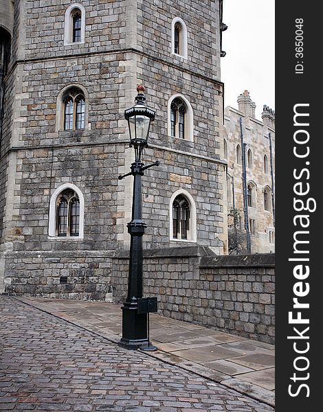 Cobbled Entrance to Windsor Castle in England with a Victorian Street Lamp in the foreground