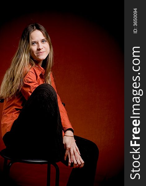 Portret of young female student on red background in studio