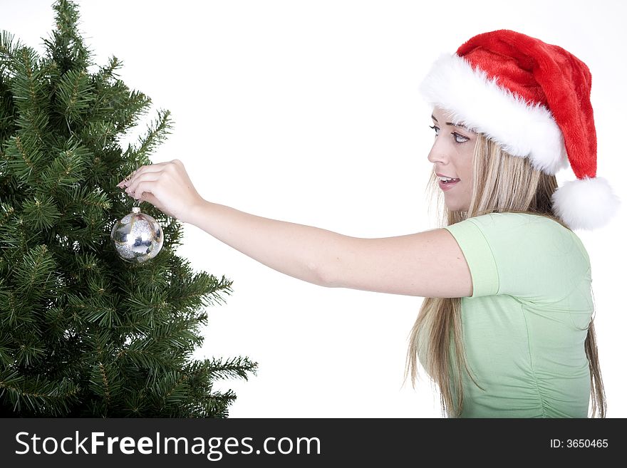 Woman fixing up christmas tree over white background