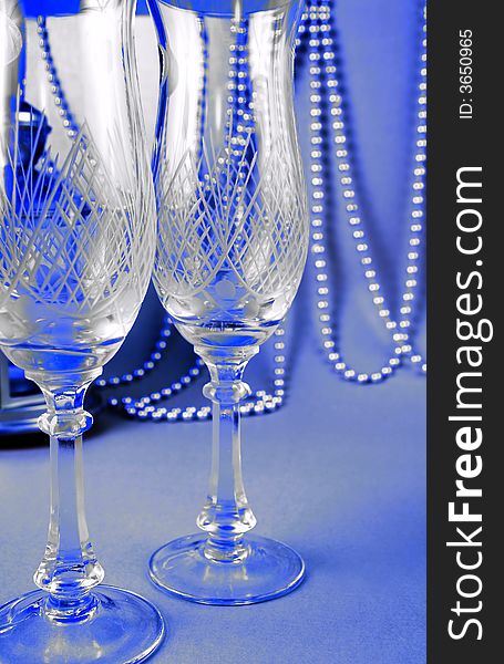 Two crystal glasses against the solemn dark-blue background. Two crystal glasses against the solemn dark-blue background