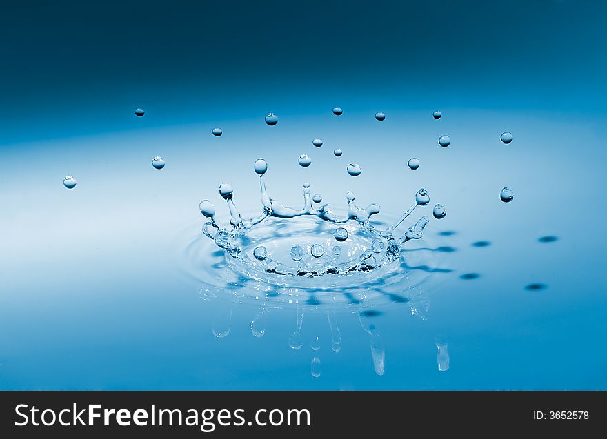 Blue crown waterdrop splashing on surface. Blue crown waterdrop splashing on surface