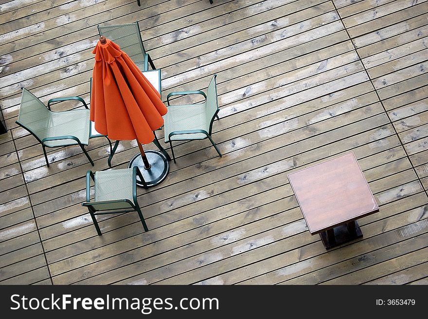 A umbrella, table and chairs in a hotel.