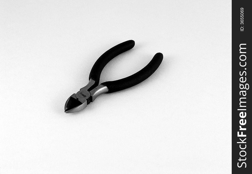 A black and white photo of a wire cutting tool. A black and white photo of a wire cutting tool.