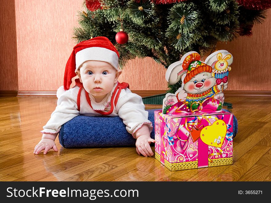 Infant with gifts in the decorated christmas box. Infant with gifts in the decorated christmas box