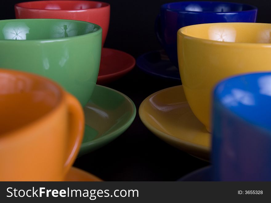 Six color cups on black background
