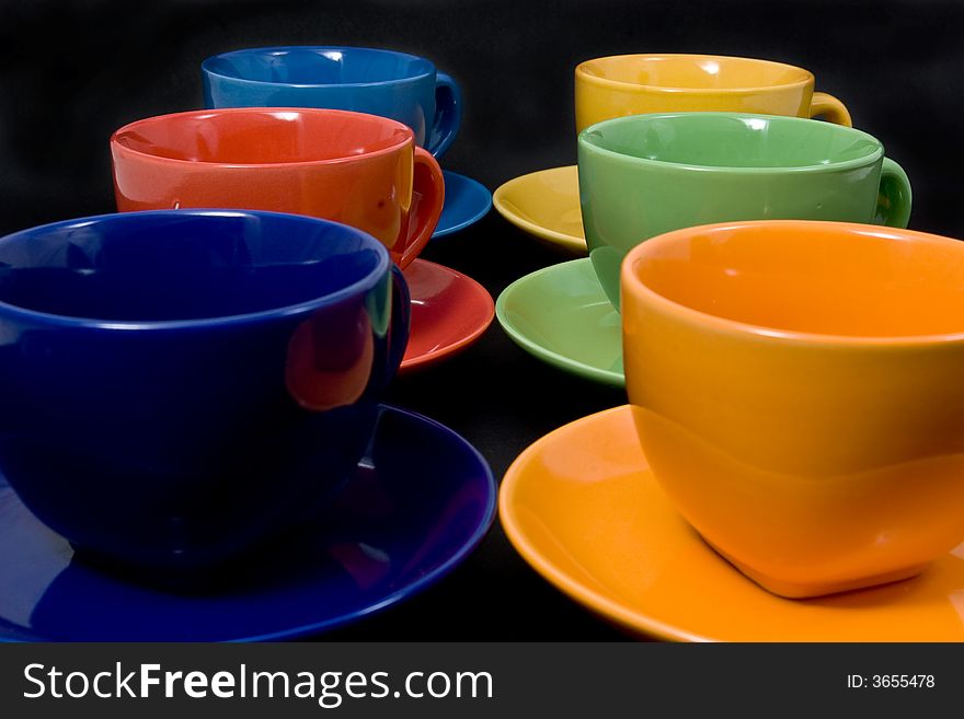 Six color cups on black background