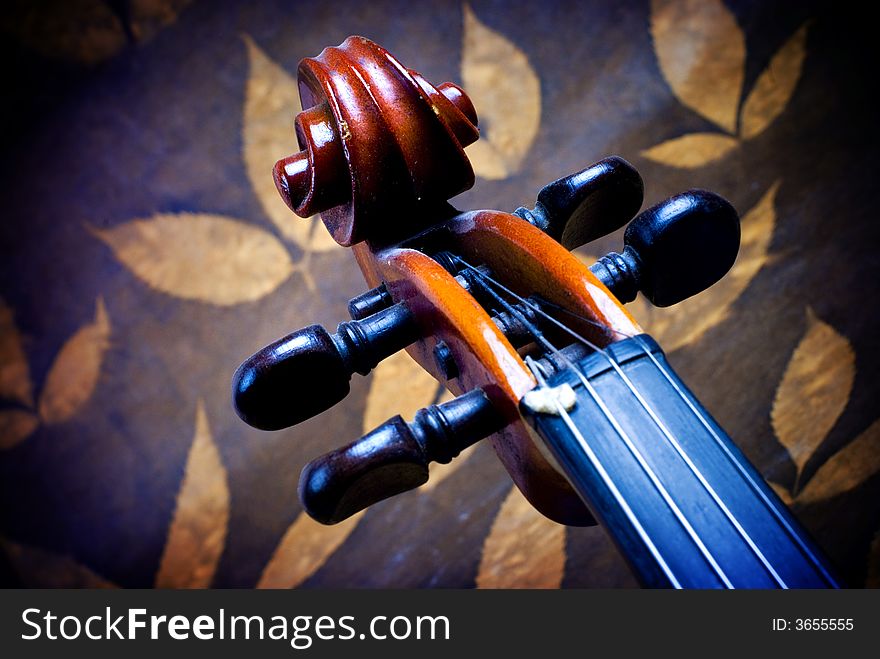 Violin details, neck with leafs background