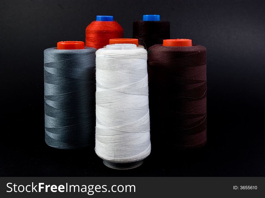 Thread spools on black background