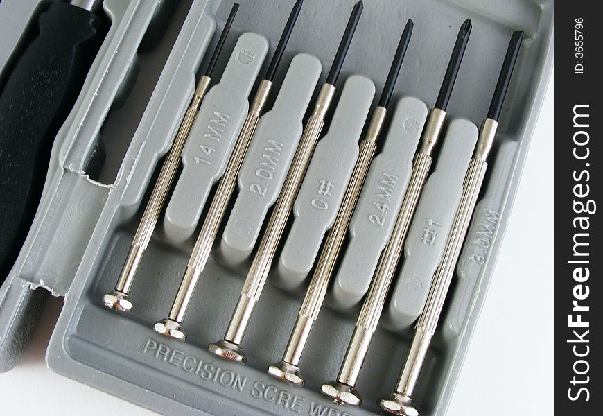 Precision screwdrivers in a plastic case against a white background. Precision screwdrivers in a plastic case against a white background.