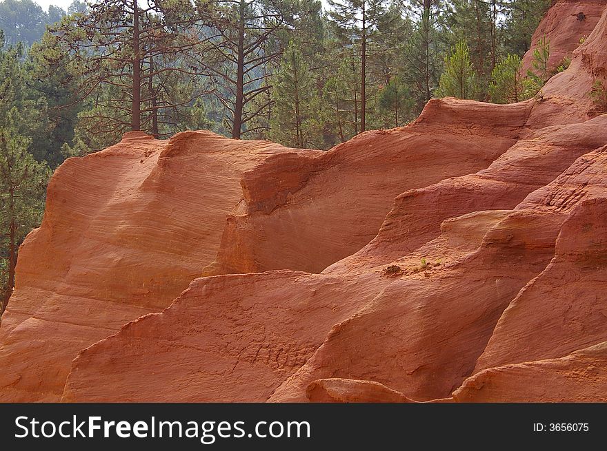 Geological landscape composed by a red rock sculpted by erosion in first plan and pine wood in background
It is in the south of France, a place called Luberon. Geological landscape composed by a red rock sculpted by erosion in first plan and pine wood in background
It is in the south of France, a place called Luberon.