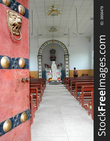 A built in the 15th century old church, With a chinese traditional door.China. A built in the 15th century old church, With a chinese traditional door.China