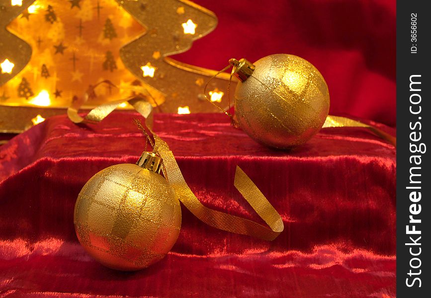 Christmas gold ornaments and gold with lamp like fir on the red background. Christmas gold ornaments and gold with lamp like fir on the red background