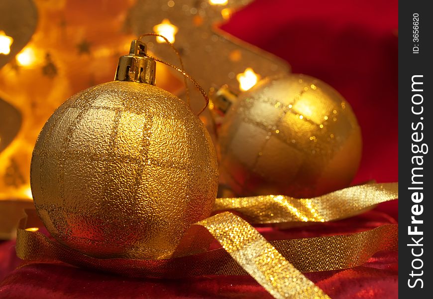 Christmas gold ornaments and gold with lamp like fir on the red background. Christmas gold ornaments and gold with lamp like fir on the red background