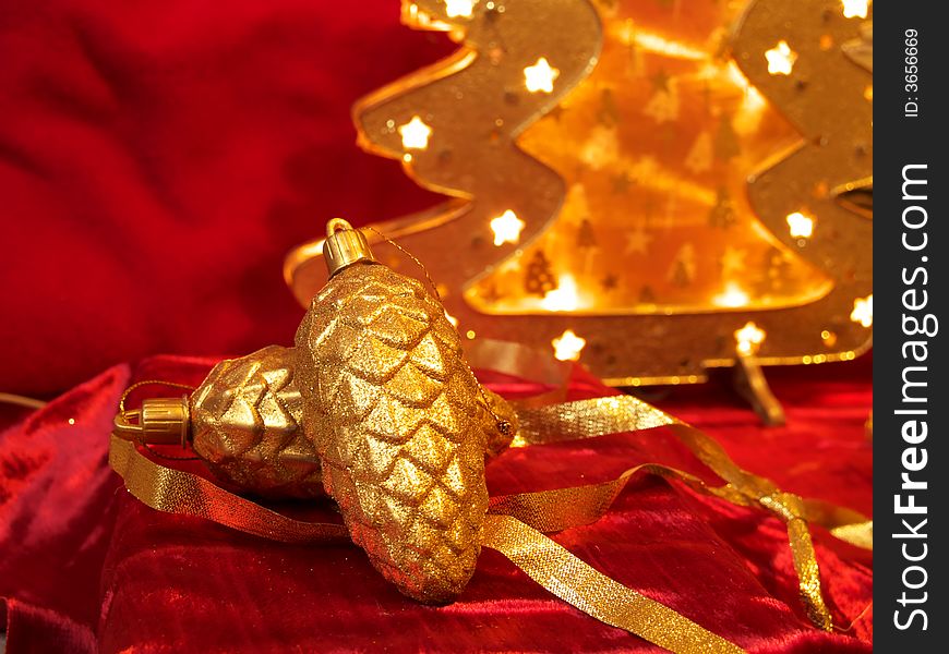 Christmas gold ornaments and gold with lamp like fir on the red background. Christmas gold ornaments and gold with lamp like fir on the red background