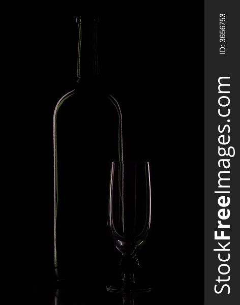 Bottle blame and empty goblet on black background. Bottle blame and empty goblet on black background