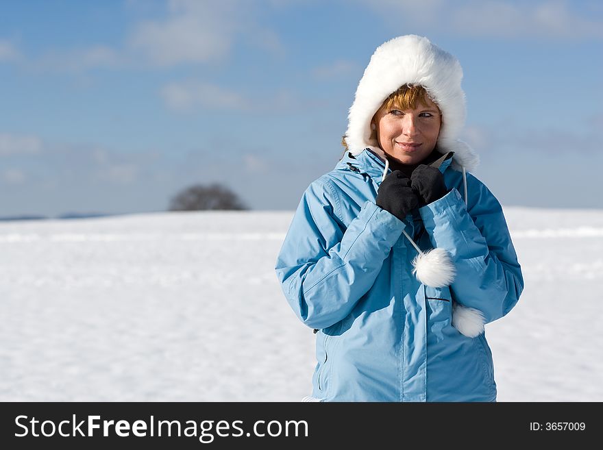 Nice woman in winter-landscape, looking to the left to the copyspace. Nice woman in winter-landscape, looking to the left to the copyspace.