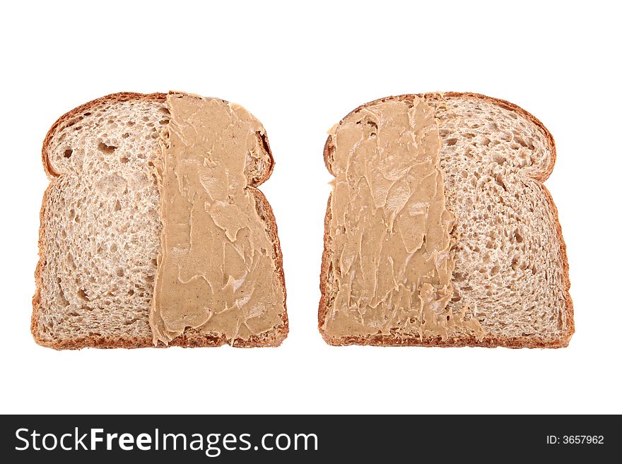 Two slices of bread buttered on an unmatching side. Two slices of bread buttered on an unmatching side
