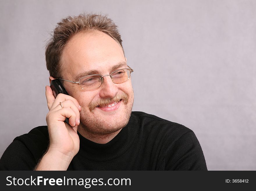 Man with beard speaks on the cell phone. Man with beard speaks on the cell phone