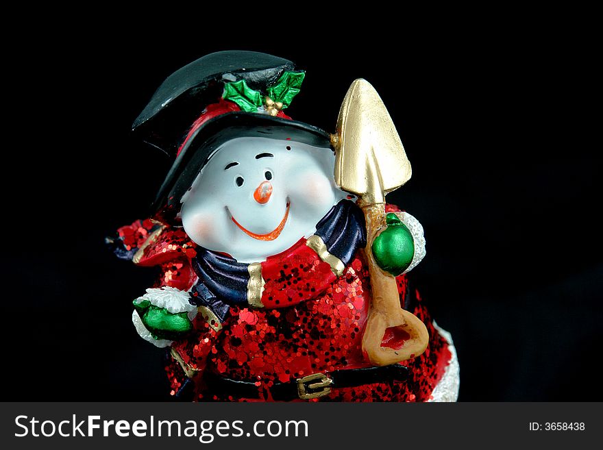 A picture of a snow santa with big smile and shovel